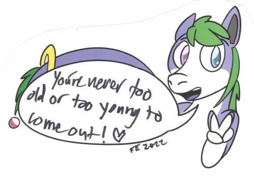 Tanby, the group mascot, a purple alien creature with green hair, smiles and flashes the peace sign!